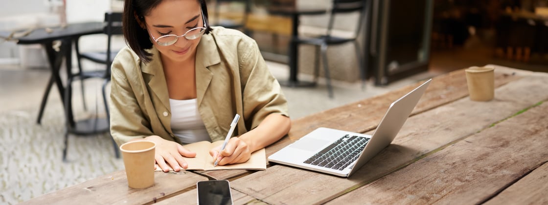 portrait-concentrated-girl-doing-homework-attending-online-course-making-notes-while-working